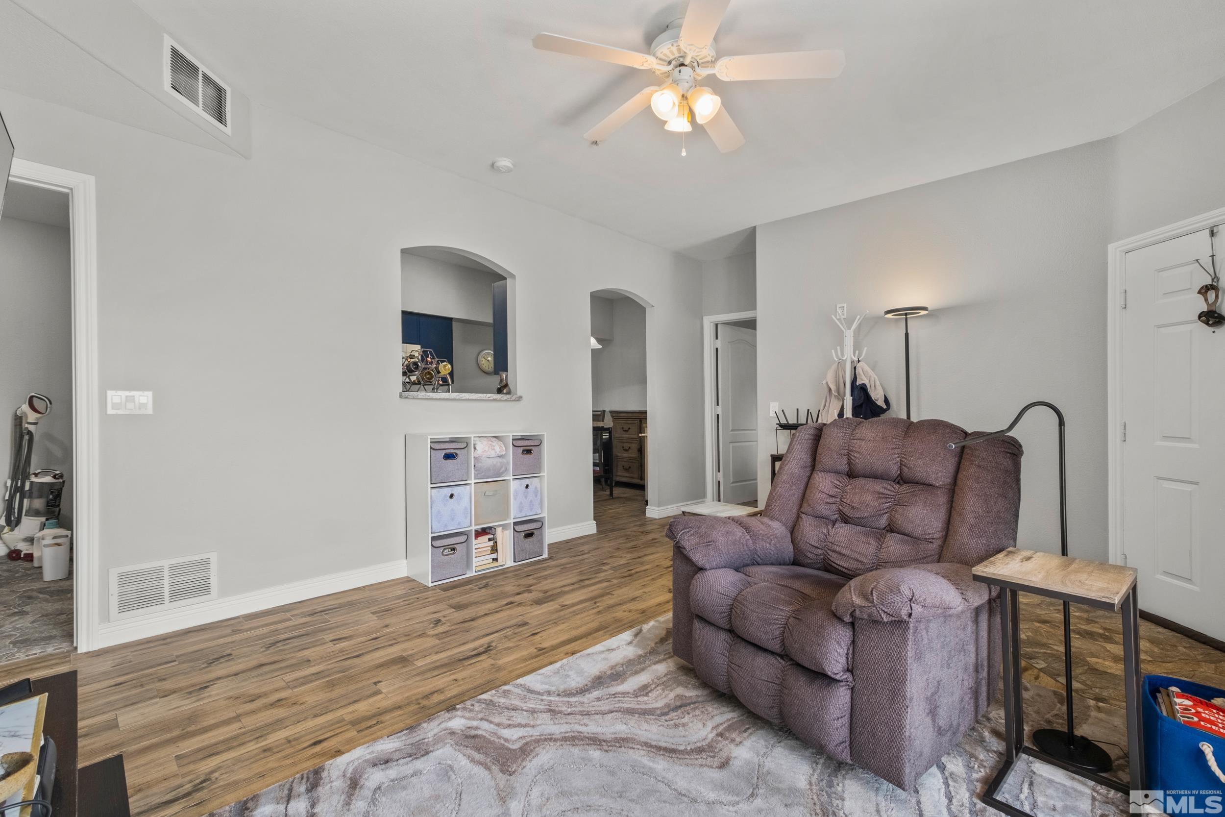 6850 Sharlands Avenue, Unit 1100 Reno, NV 89523 - Photo 13 of 26 a living room with furniture and a wooden floor