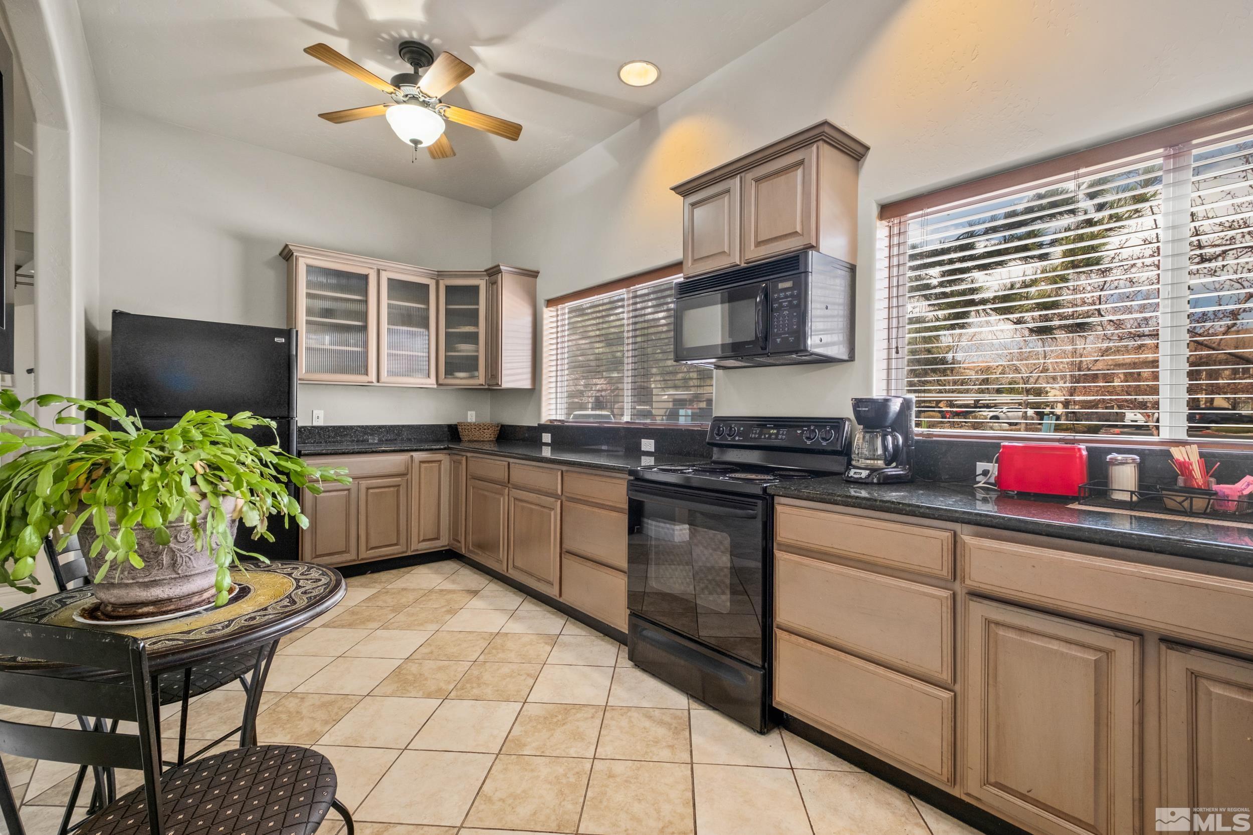 6850 Sharlands Avenue, Unit 1100 Reno, NV 89523 - Photo 23 of 26 a kitchen with a stove a sink cabinets and appliances