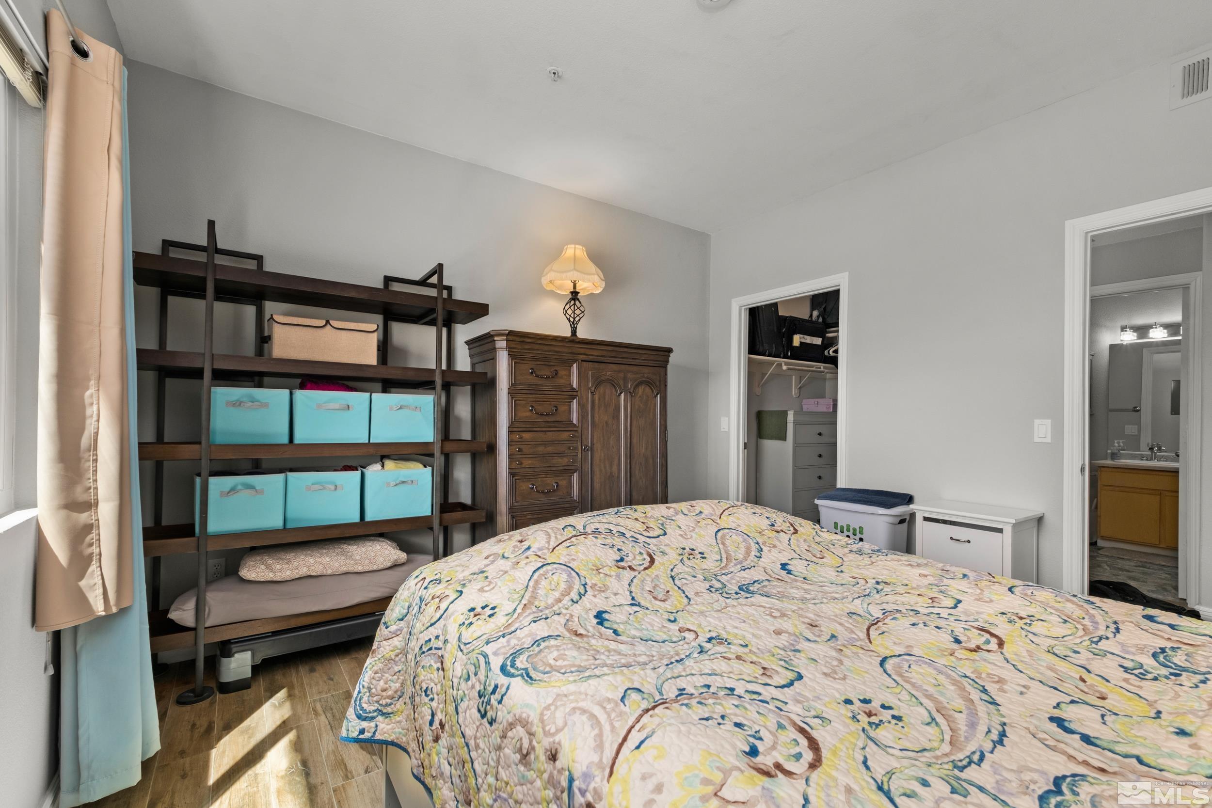 6850 Sharlands Avenue, Unit 1100 Reno, NV 89523 - Photo 10 of 26 a bedroom with a bed a dresser and a mirror