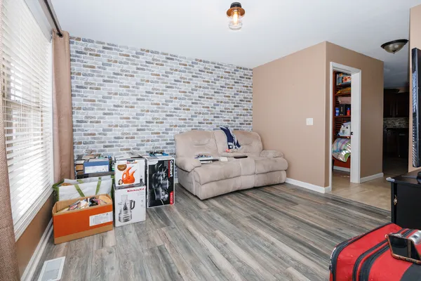 a bedroom with furniture and a wooden floor