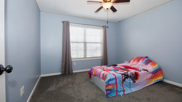 a bedroom with a bed and window