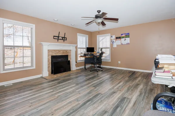 a view of livingroom with hardwood floor and a fireplace