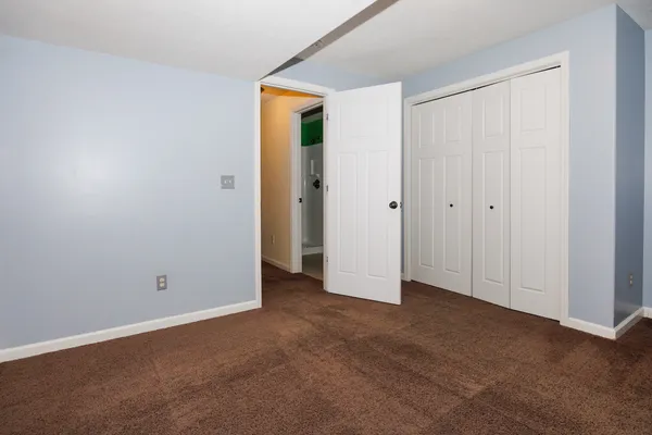 a view of a yard with wooden fence