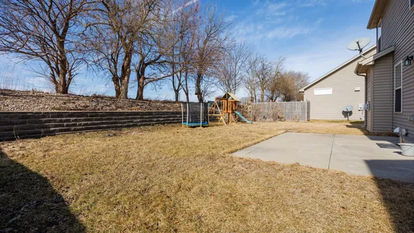 a view of yellow house with a yard