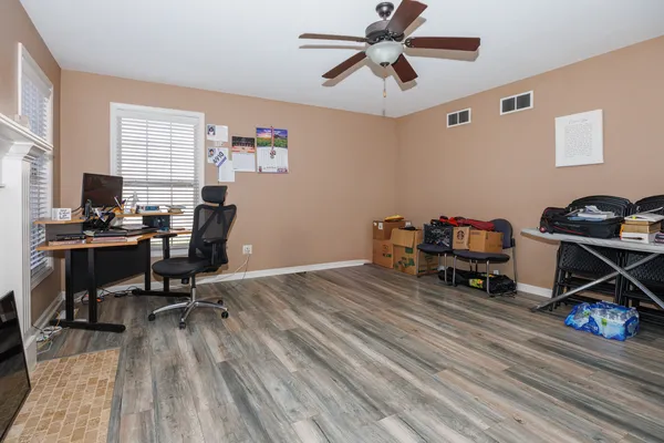 a view of a workspace with furniture and a window