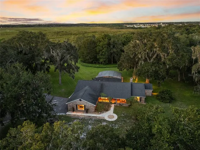 an aerial view of a house with garden space and outdoor seating