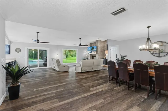 a living room with furniture chandelier and a window