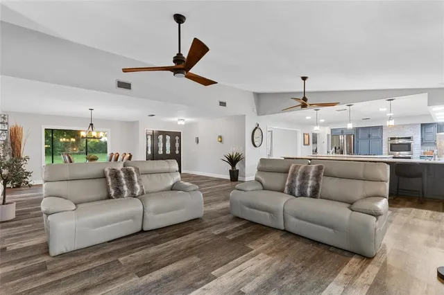 a living room with furniture and a ceiling fan