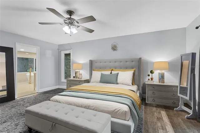 a bedroom with a large bed and a chandelier