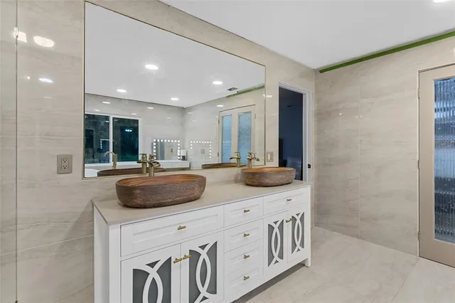a kitchen with kitchen island a sink and a refrigerator