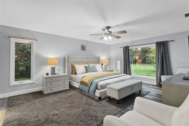 a spacious bedroom with a bed and a large window