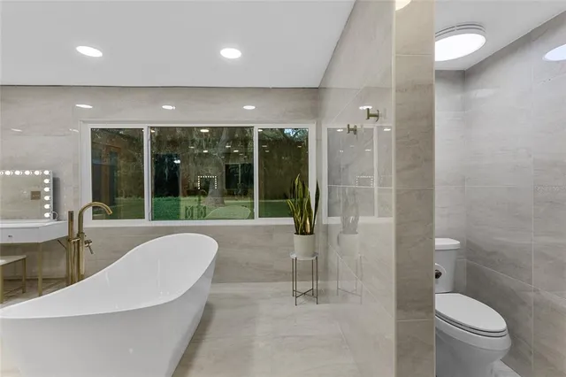 a spacious bathroom with a large tub and shower
