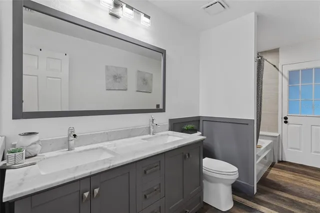 a bathroom with a toilet sink and mirror