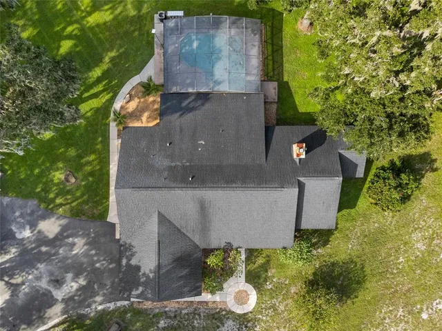 an aerial view of a house with yard swimming pool and outdoor seating