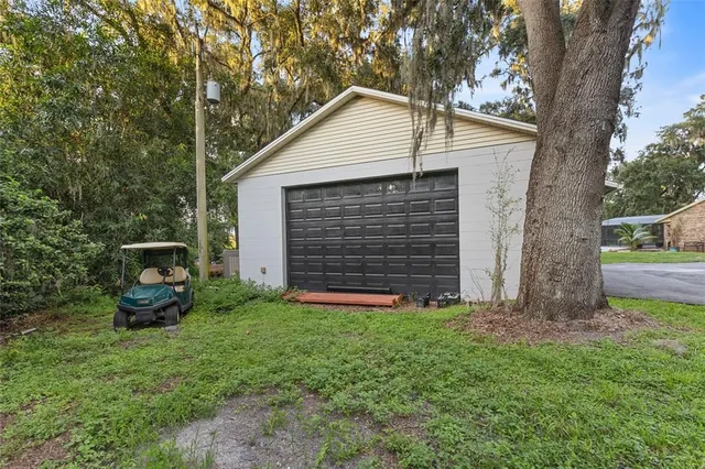 a front view of house with yard and trees in the background