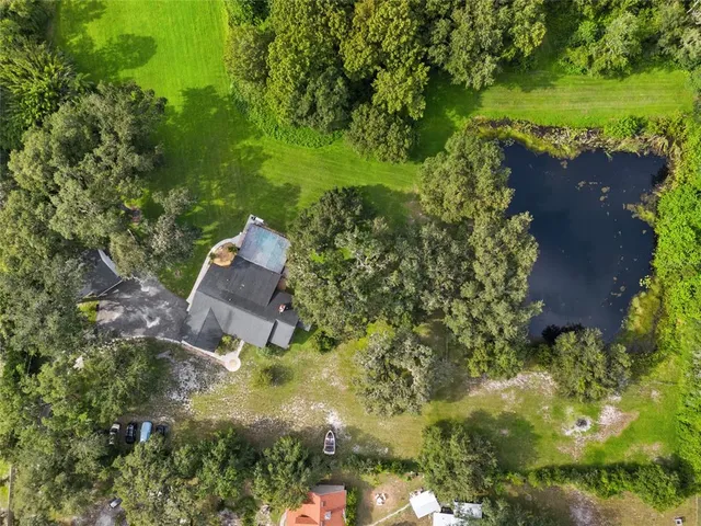 an aerial view of a house with a yard