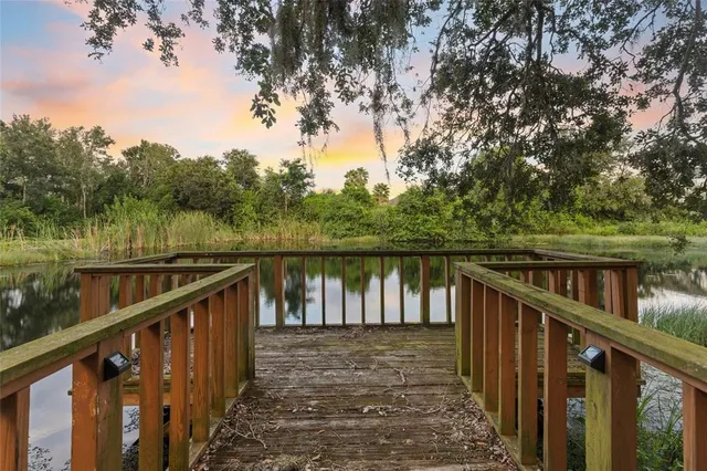 a balcony with wooden floor and lake view