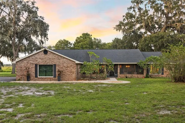 a front view of house with yard and green space