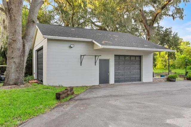 a front view of house with yard and trees in the background