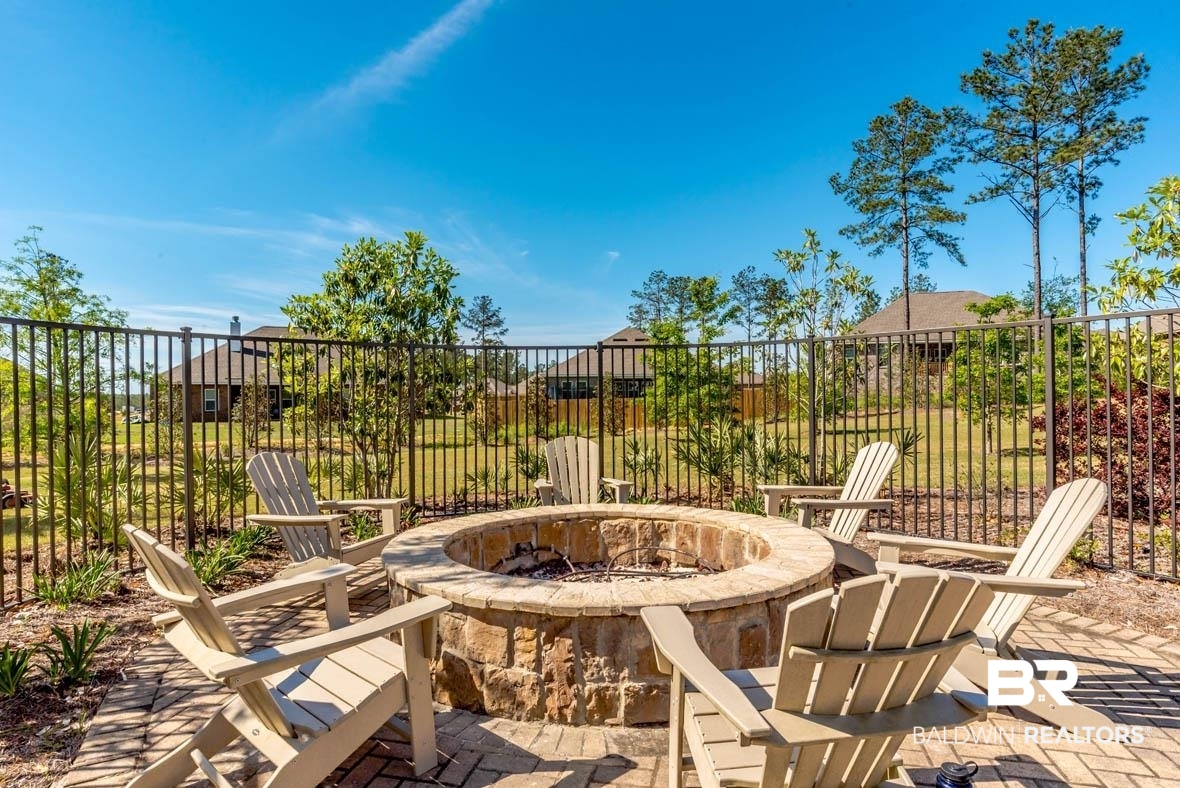 32125 Lyon Road Daphne, AL 36527 - Photo 55 of 70 Outdoor patio featuring a stone fire pit, paver flooring, and surrounding landscaping