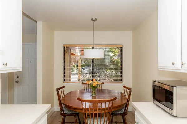 a dining room with furniture a chandelier and wooden floor