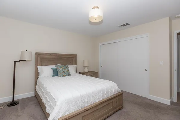 a bedroom with a bed and a lamp