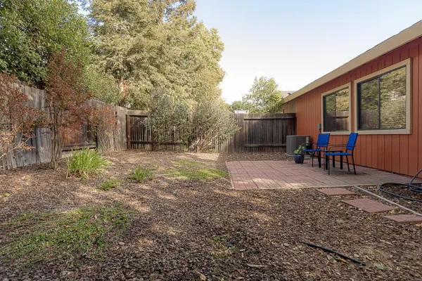 a view of a backyard with furniture and a yard