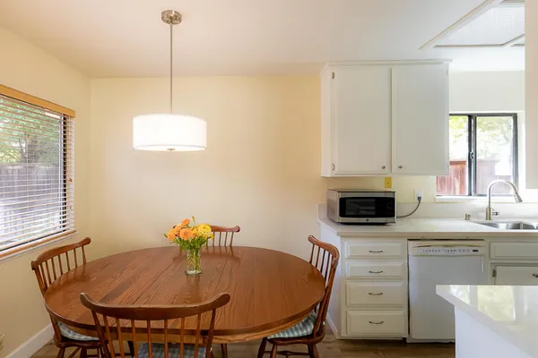 a kitchen with a appliances cabinets and a table