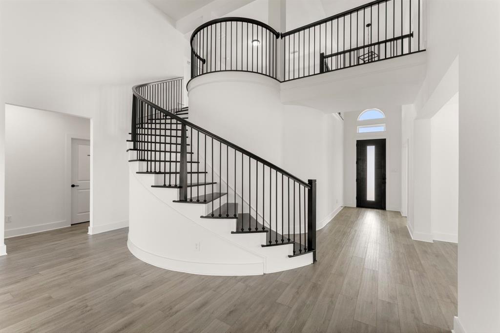 9621 Chesney Drive Forney, TX 75126 - Photo 15 of 36 a view of staircase with railing and a chandelier