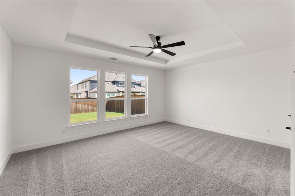 9621 Chesney Drive Forney, TX 75126 - Photo 28 of 36 an empty room with windows and ceiling fan view