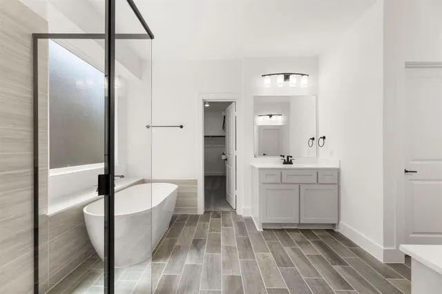 a bathroom with a sink a mirror and a bathtub