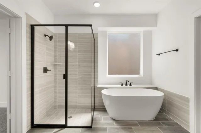 a bathroom with a bathtub and shower