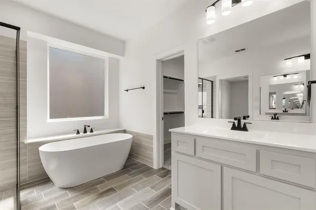 a view of a bathroom with a sink and mirror