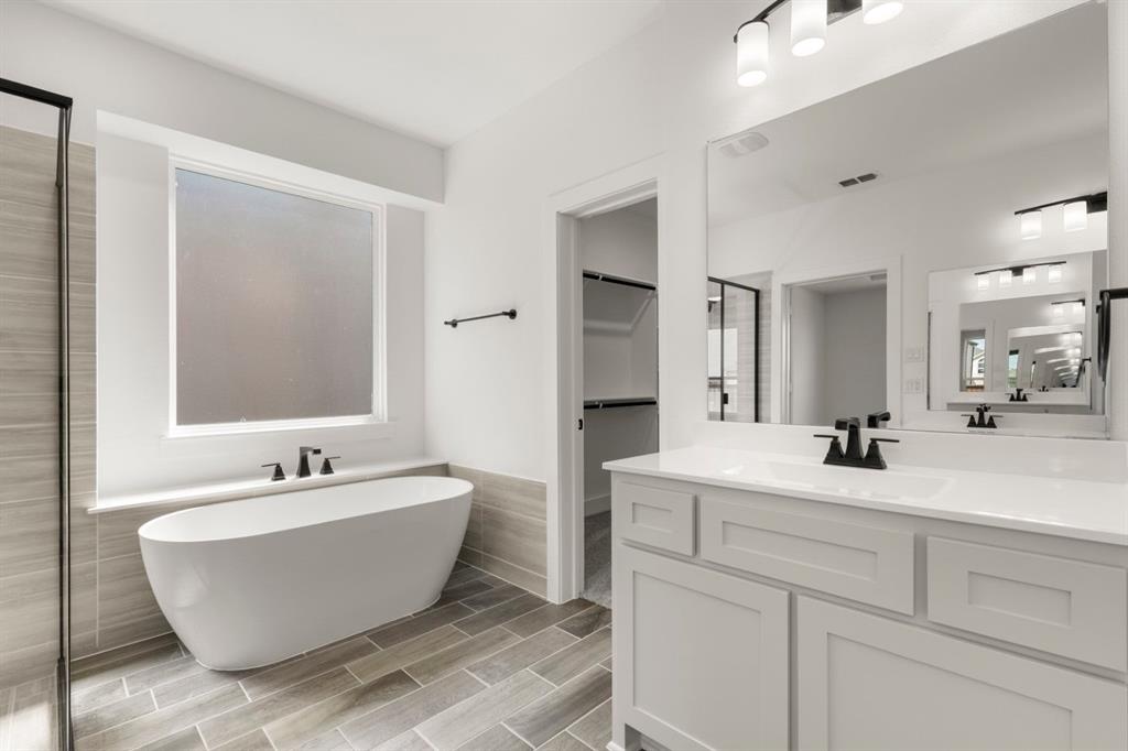 9621 Chesney Drive Forney, TX 75126 - Photo 32 of 36 a view of a bathroom with a sink and mirror