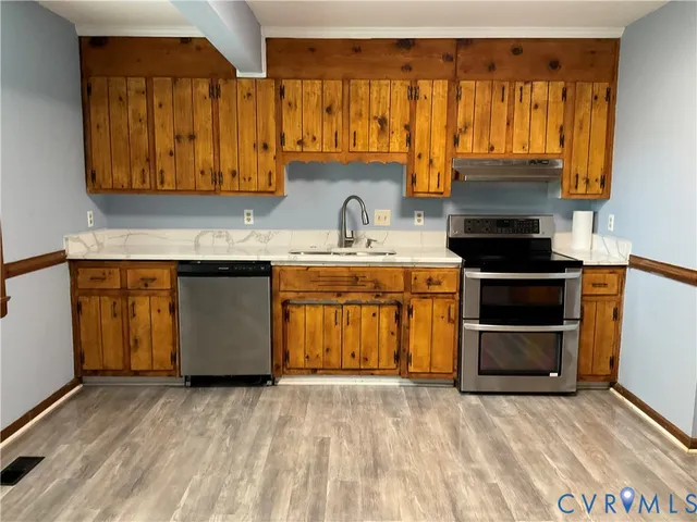 a view of a kitchen with wooden floor and a sink