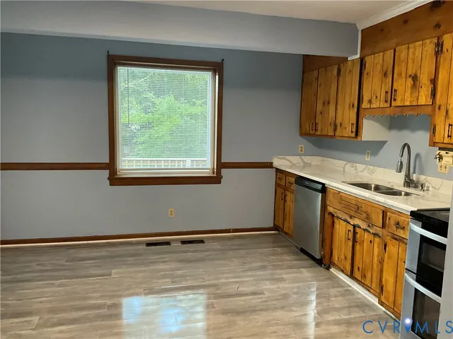 a kitchen with a sink stove top oven and cabinets