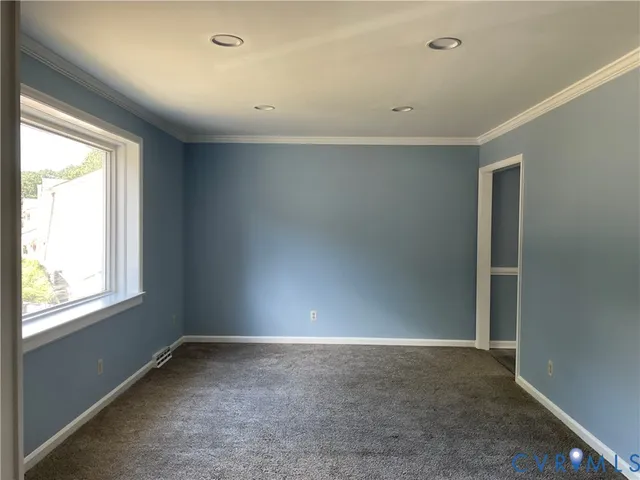 a view of a hallway with wooden floor and stairs