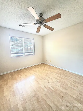 an empty room with a empty space and windows