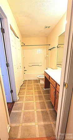 a bathroom with a glass door shower and a sink
