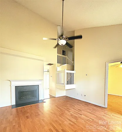 a view of a livingroom with a fireplace and wooden floor