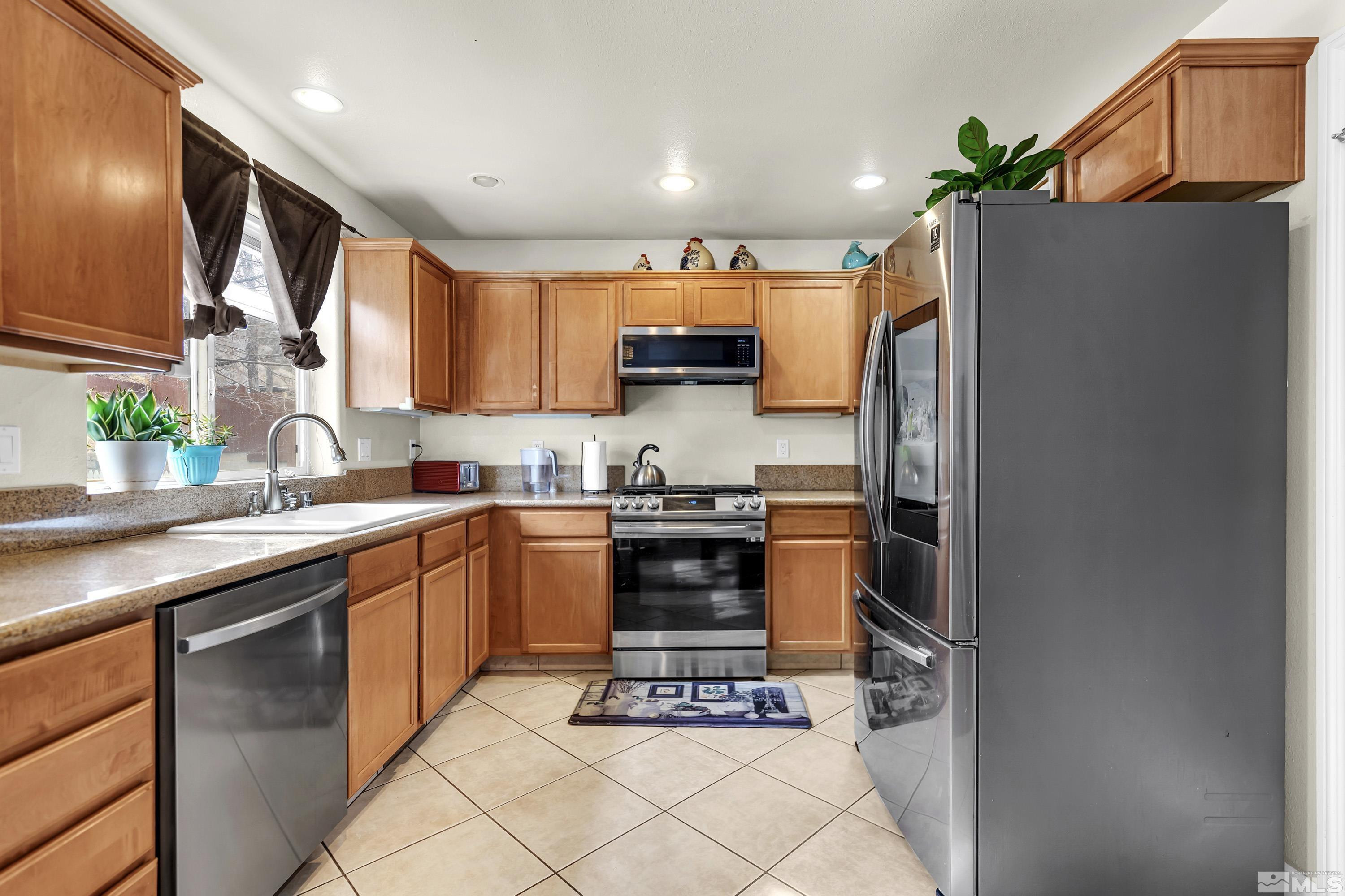 6750 Peppermint Court Reno, NV 89506 - Photo 13 of 33 a kitchen with stainless steel appliances a refrigerator sink and stove top oven
