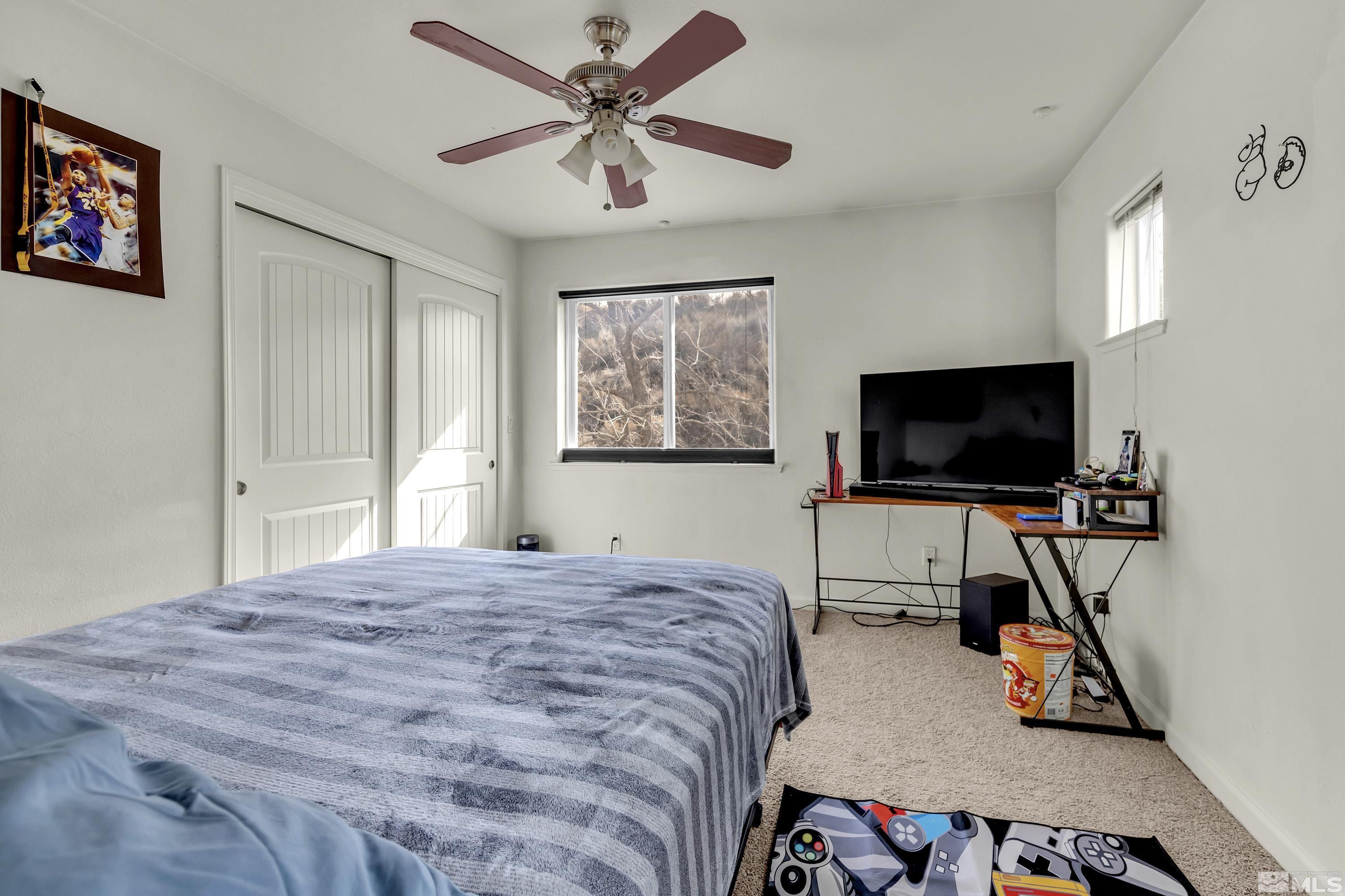 6750 Peppermint Court Reno, NV 89506 - Photo 16 of 33 a bedroom with a bed and a flat screen tv