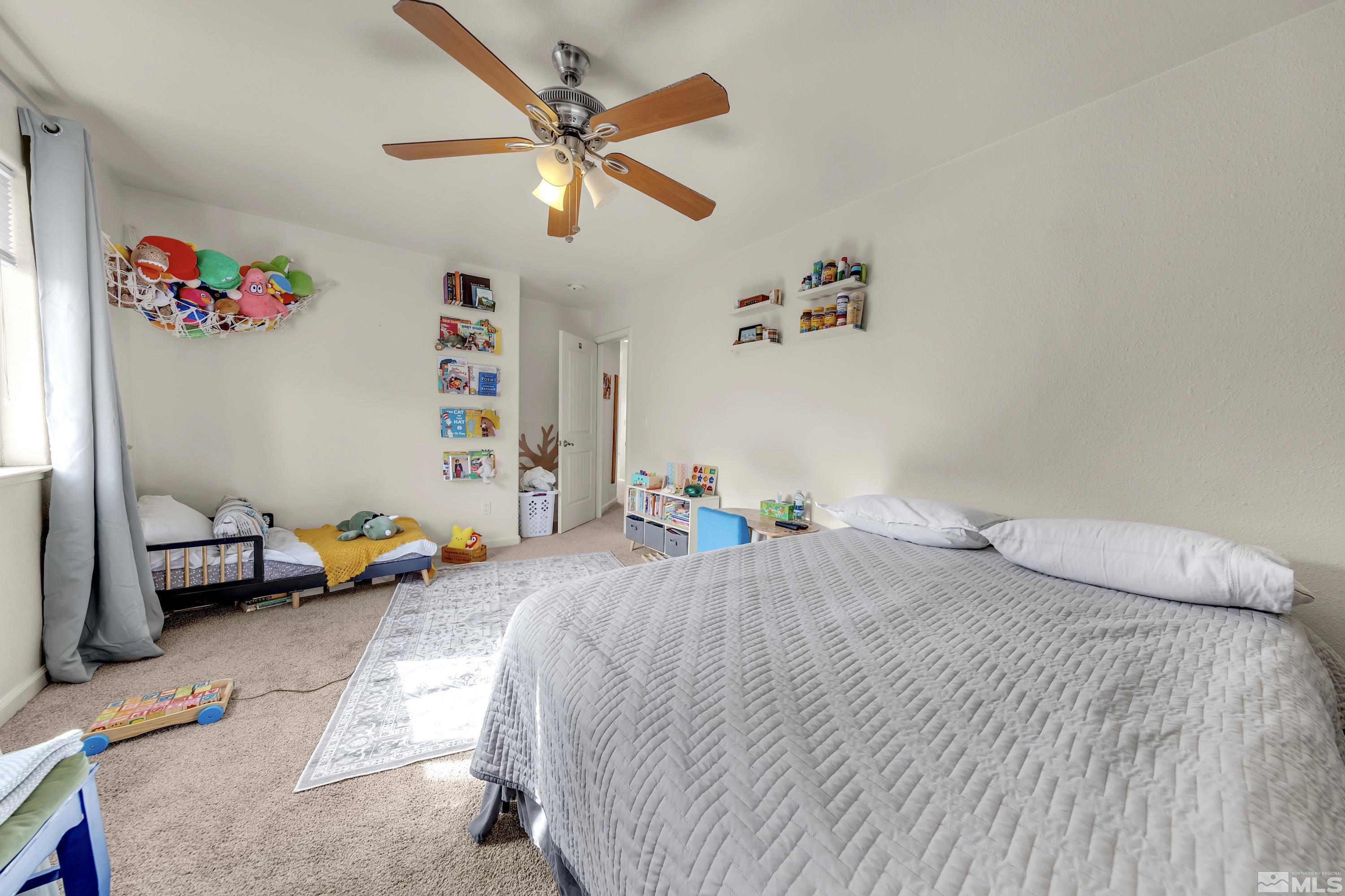 6750 Peppermint Court Reno, NV 89506 - Photo 18 of 33 a bedroom with a bed and a chandelier