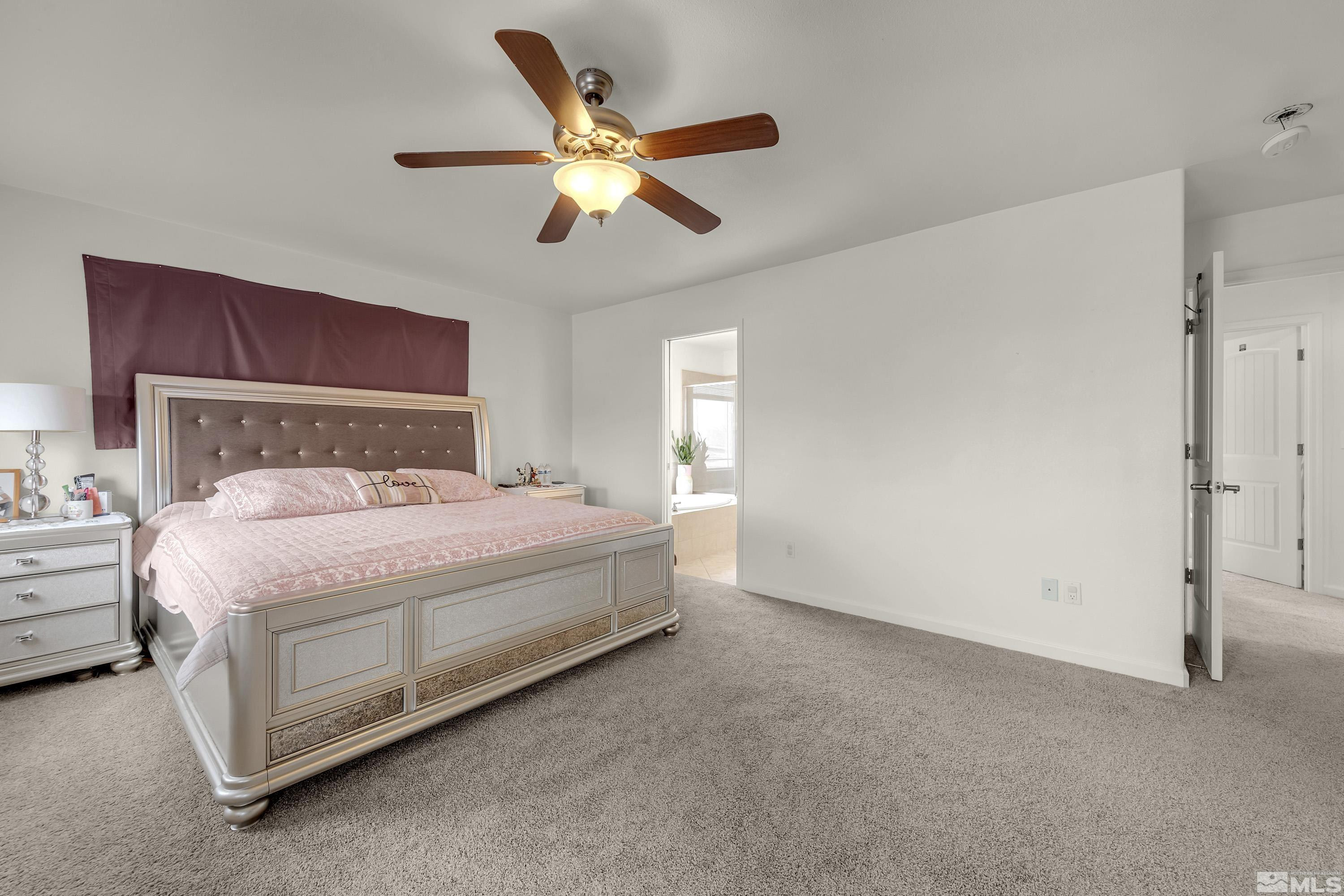 6750 Peppermint Court Reno, NV 89506 - Photo 21 of 33 a bedroom with a bed and a chandelier