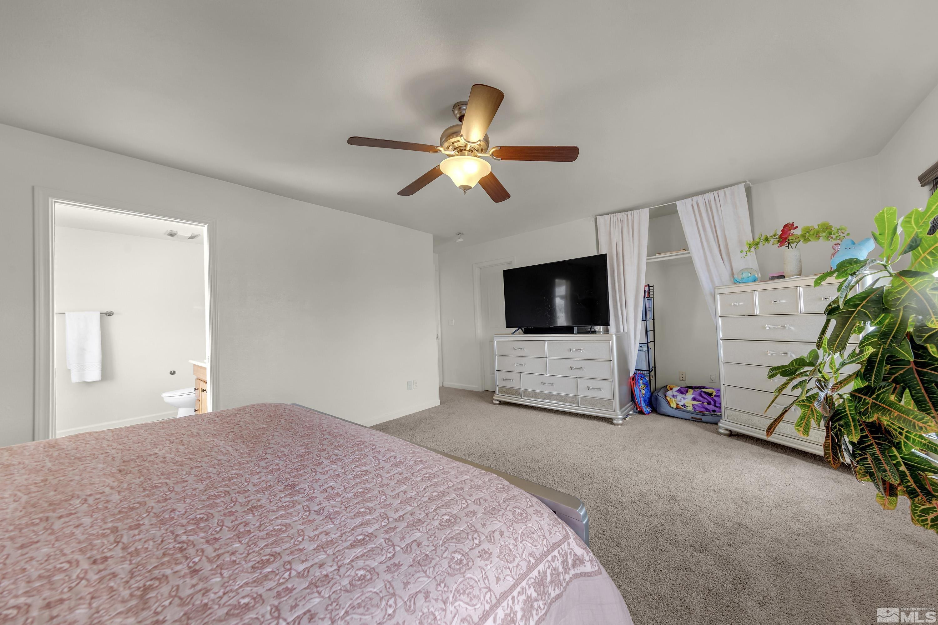 6750 Peppermint Court Reno, NV 89506 - Photo 22 of 33 a bedroom with furniture and a flat screen tv