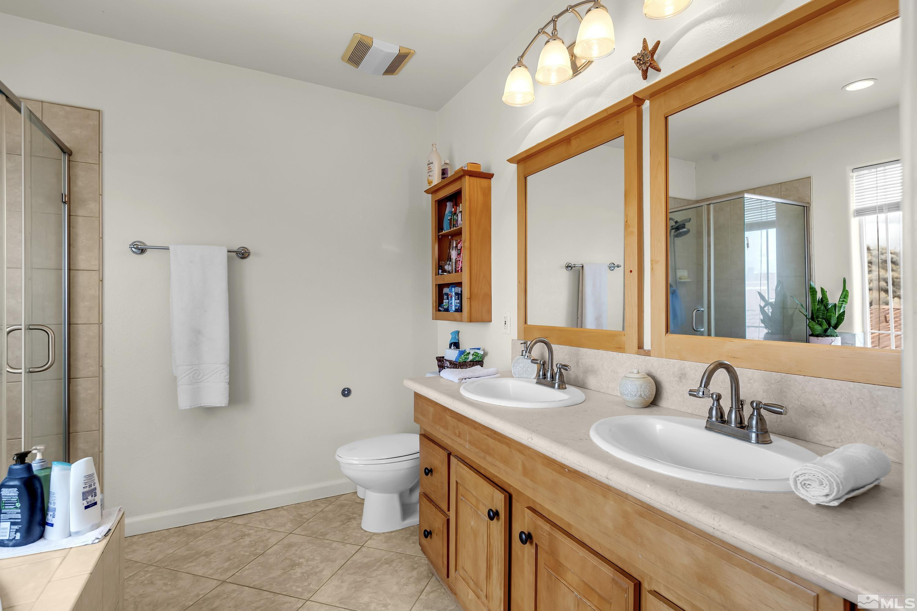 6750 Peppermint Court Reno, NV 89506 - Photo 24 of 33 a bathroom with a double vanity sink mirror and toilet