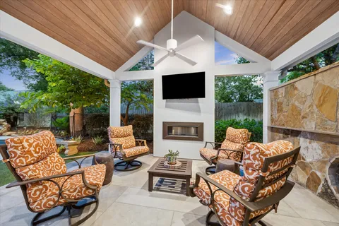 a outdoor living space with patio furniture and a fireplace