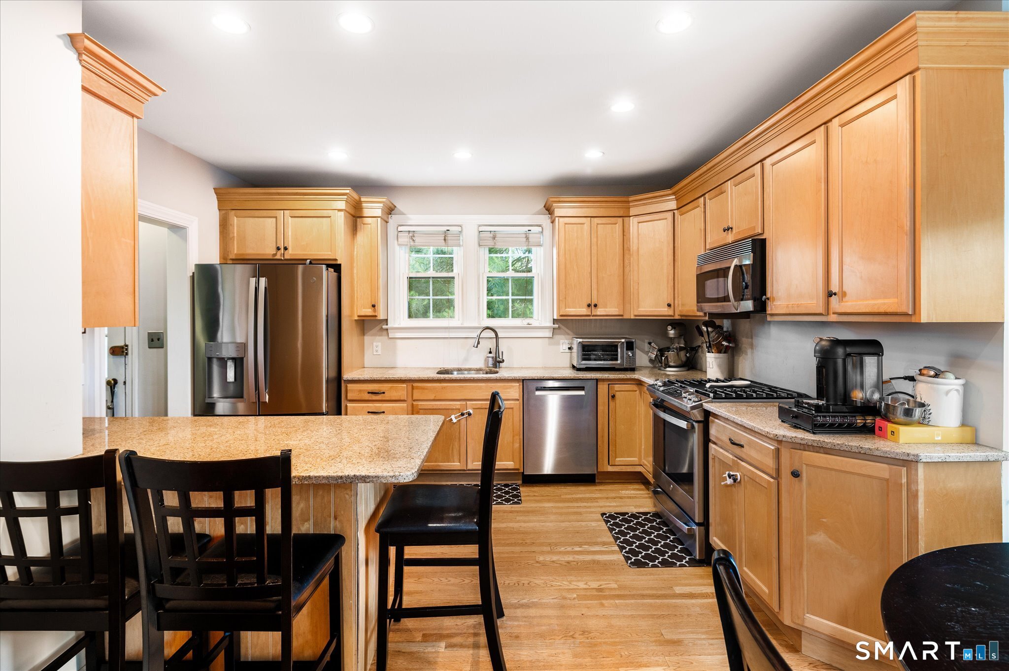 250 High Ridge Road Stamford, CT 06905 - Photo 3 of 22 The well appointed kitchen with built in breakfast bar, loads of cabinetry and beautiful appliances