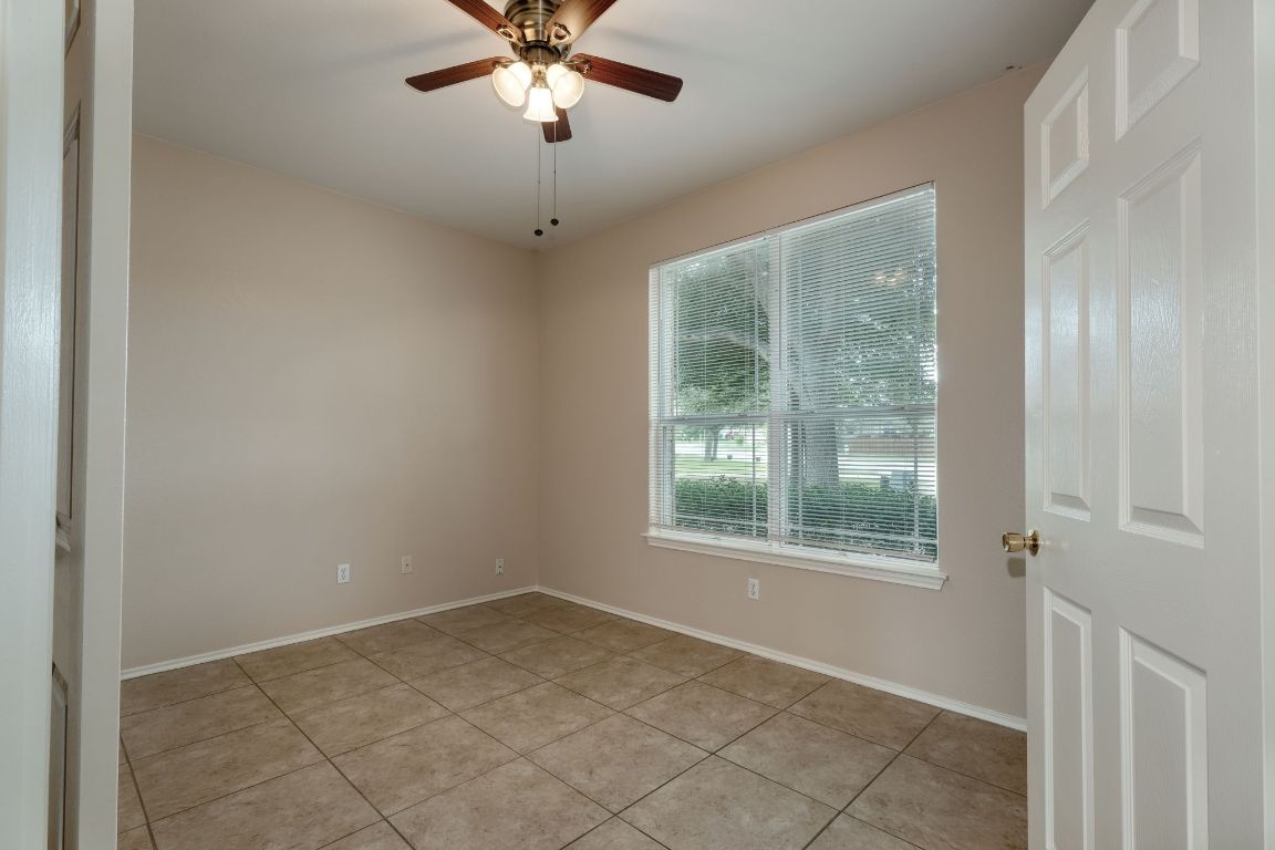 116 Rio Grande Drive Kyle, TX 78640 - Photo 5 of 13 Empty room with light tile patterned floors and ceiling fan