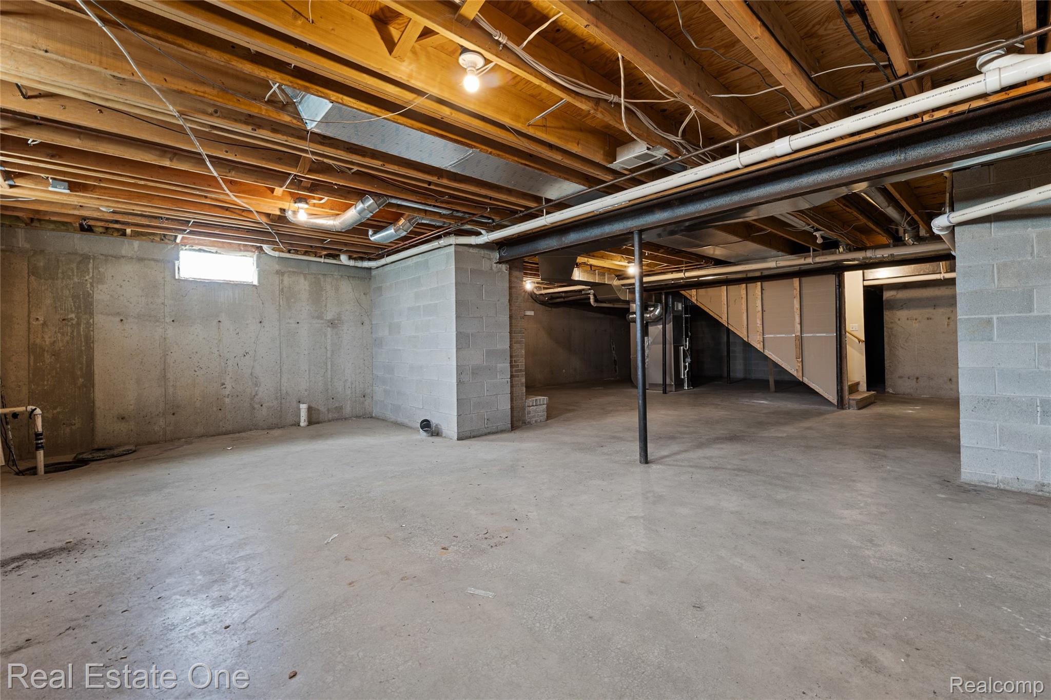 17268 Beech Daly Road Romulus, MI 48174 - Photo 60 of 60 Unfinished lower level with concrete flooring, exposed wood joists, and concrete block walls